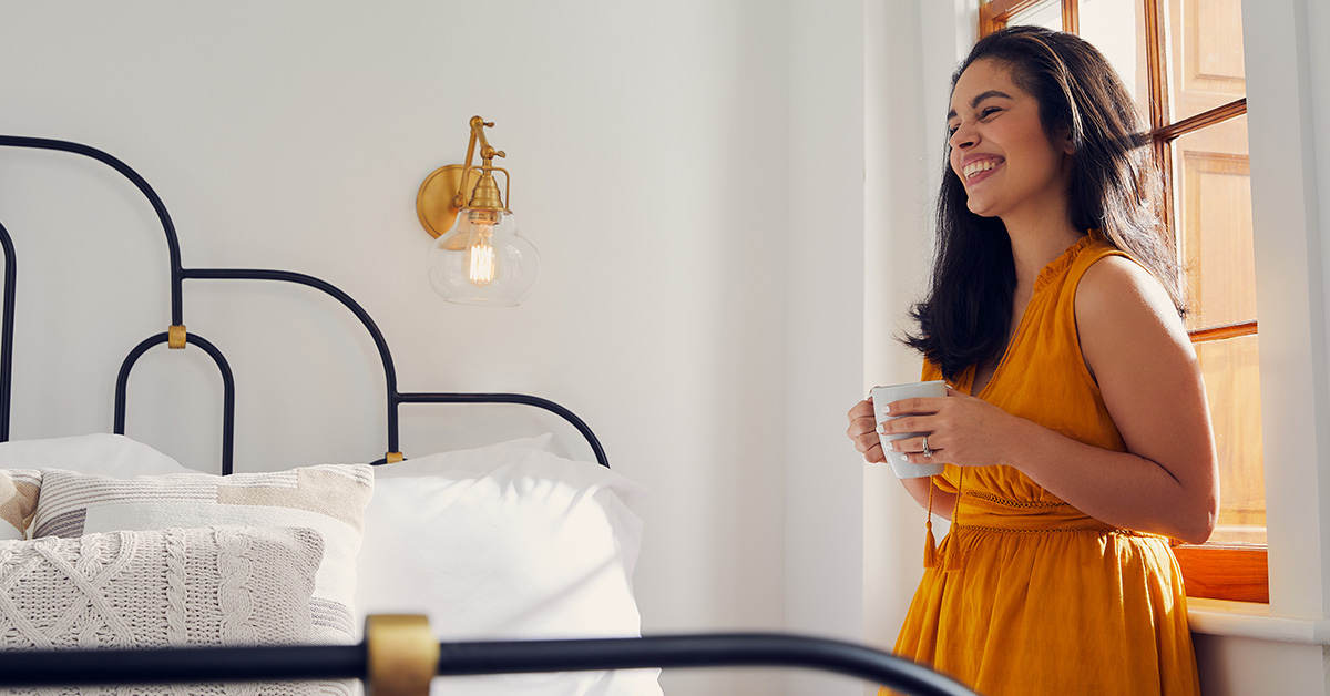 Woman smiling in bedroom